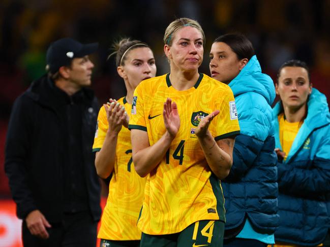 Australia's defender #14 Alanna Kennedy (C) and injured Australia's captain Sam Kerr (2nd R) applaud the fans after their team's loss to Nigeria. Picture: Patrick Hamilton / AFP.