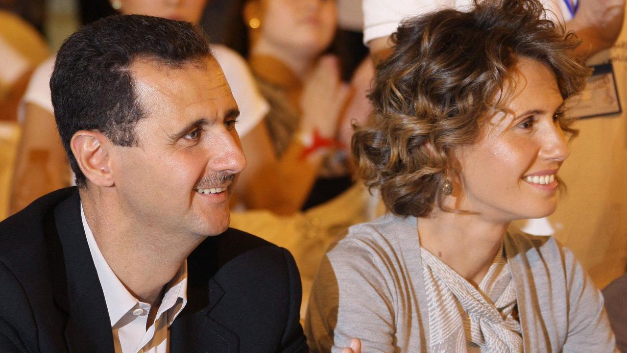 Syria's ousted president Bashar Assad and his wife Asma visit a group of young athletes of special needs gathered at a hotel in Damascus late on September 5, 2010. (Photo by Louai BESHARA / AFP)