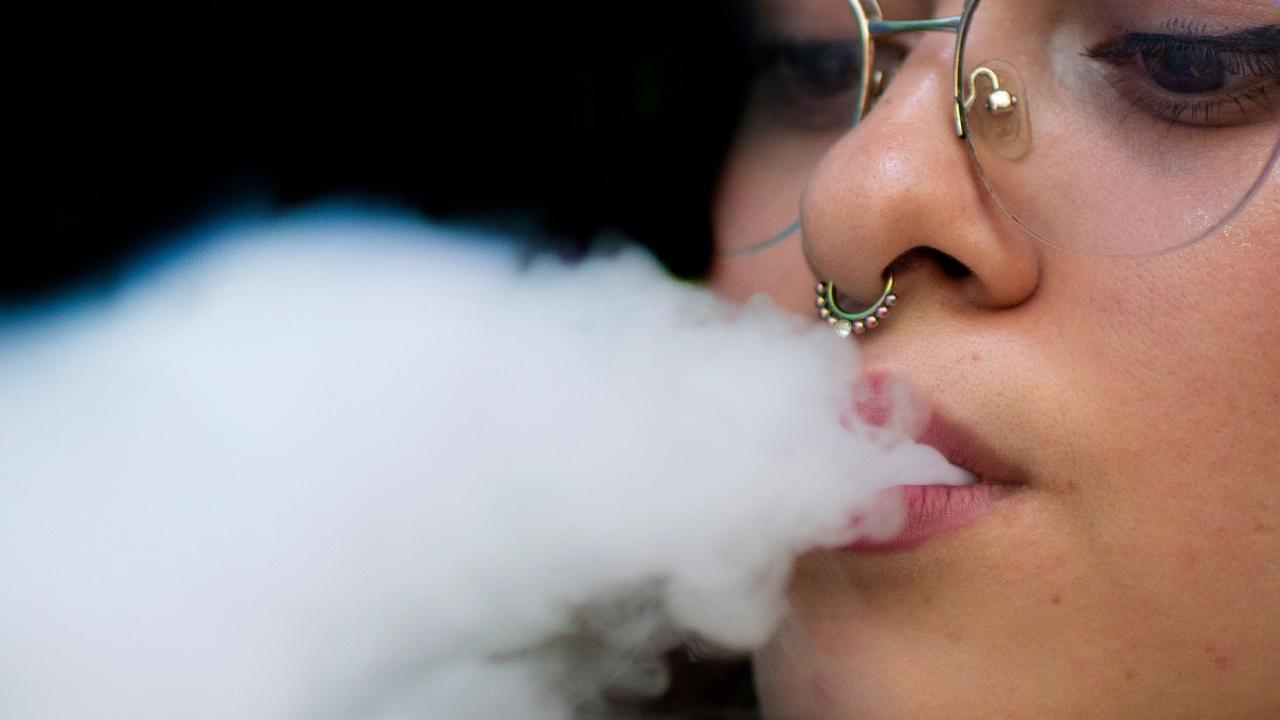 A woman blows smoke from an electronic cigarette. Picture: Ezequiel Becerra, AFP