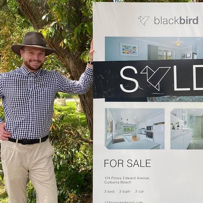 Former South Coast real estate agent Slade Small with one of the properties he's alleged to have pocketed some of the deposit for. Picture: Facebook