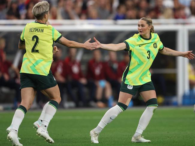 Matildas goalscorer Michelle Heyman (left) receives congratulations from teammate Winonah Heatley. Picture: Chris Coduto / Getty Images North America / Getty Images via AFP