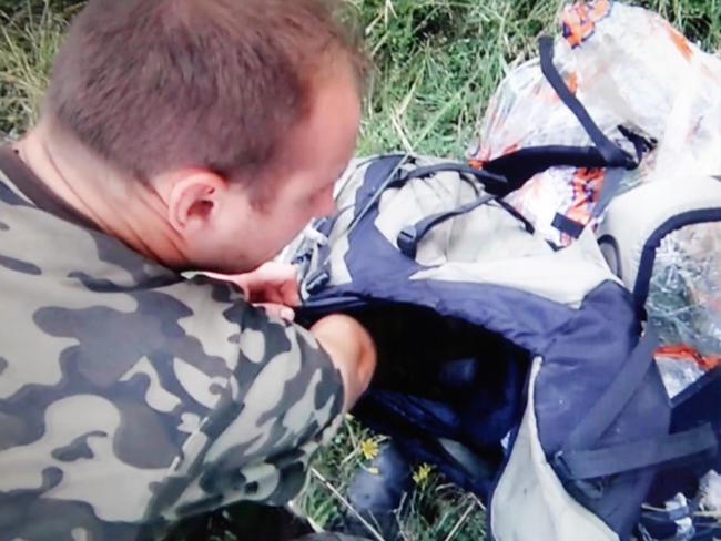 News Corp captured footage of militia ransacking passenger bags and personal belongings at the crash site. Picture: News Corp Australia