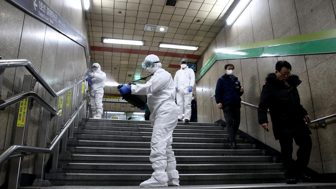 Disinfection workers wearing protective gears spray antiseptic solution against the coronavirus. Picture: Chung Sung-Jun/Getty Images