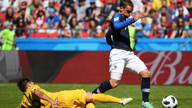 Antoine Griezmann goes down under the tackle of Josh Risdon.