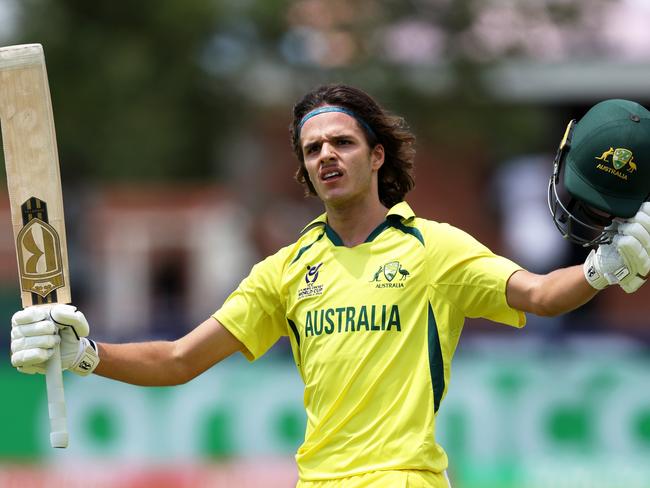 KIMBERLEY, SOUTH AFRICA - FEBRUARY 02: Sam Konstas of Australia raises his bat and helmet as he celebrates after reaching his century during the ICC U19 Men's Cricket World Cup South Africa 2024 Super Six match between West Indies and Australia at Diamond Oval on February 02, 2024 in Kimberley, South Africa. (Photo by Matthew Lewis-ICC/ICC via Getty Images)