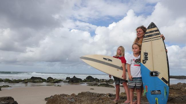 Surfer Leesa Laug has been hit by a longboarder not wearing a leg rope at Snapper Rocks. She is pictured with son Tai, 7, and Kade, 9. Picture Glenn Hampson.