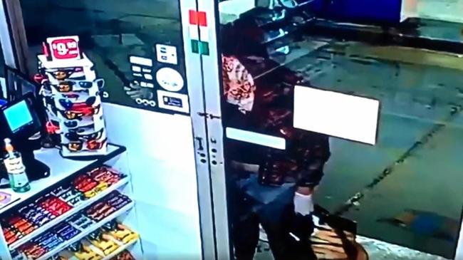 SCARY ORDEAL: CCTV footage shows a brazen attempted robbery at a Bundaberg service station where the offender knocks on the door with a large kitchen knife. Picture: Contributed