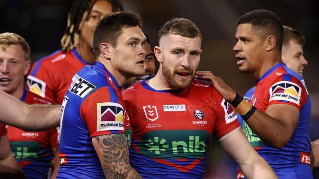 NEWCASTLE, AUSTRALIA - APRIL 09: Jackson Hastings of the Knights is embraced by team mates following a try that was later disallowed during the round six NRL match between Newcastle Knights and New Zealand Warriors at McDonald Jones Stadium on April 09, 2023 in Newcastle, Australia. (Photo by Cameron Spencer/Getty Images)