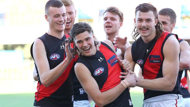 Sam Durham (centre) celebrates his first win on debut. Picture: AFL Photos/via Getty Images