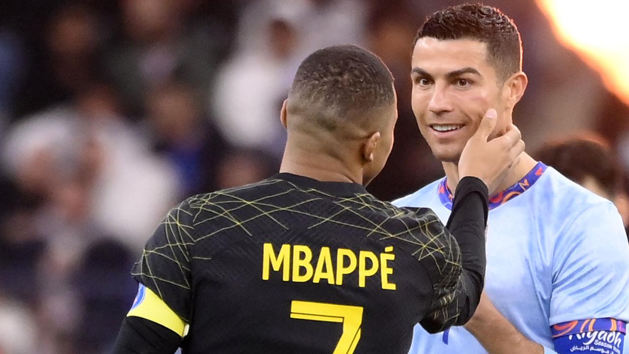 Paris Saint-Germain's French forward Kylian Mbappe greets Riyadh All-Star's Portuguese forward Cristiano Ronaldo during the Riyadh Season Cup football match at King Fahd Stadium in Riyadh on January 19, 2023. (Photo by FRANCK FIFE / AFP)