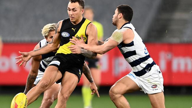 Shai Bolton kicks the ball as he is tackled by Brandan Parfitt during Sunday’s heavy defeat.