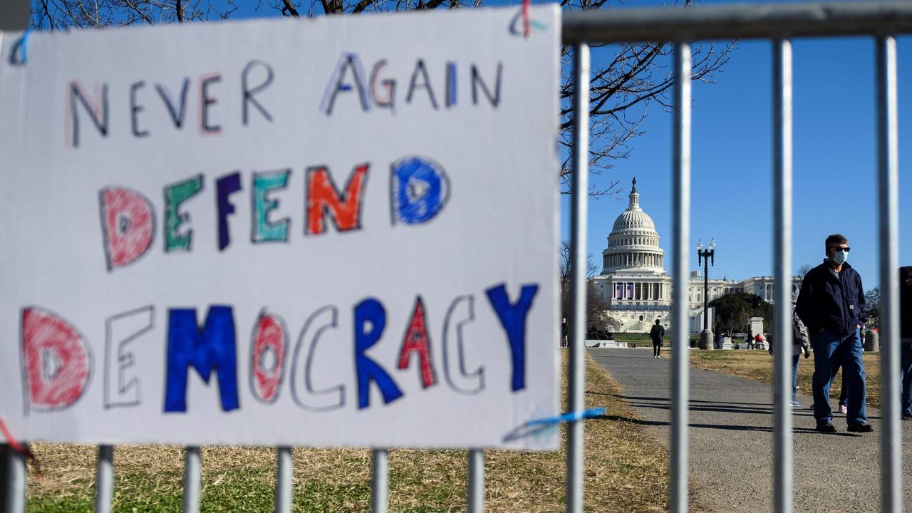 People pass signs of support in Washington following the storming the Capitol. Picture: Andrew Caballero-Reynolds/AFP