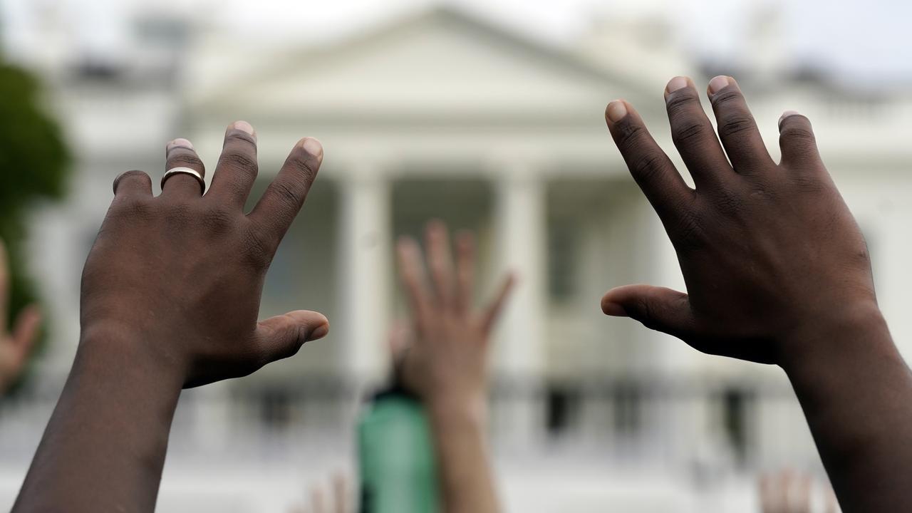 Demonstrators gather across from the White House. Picture: AP Photo/Evan Vucci