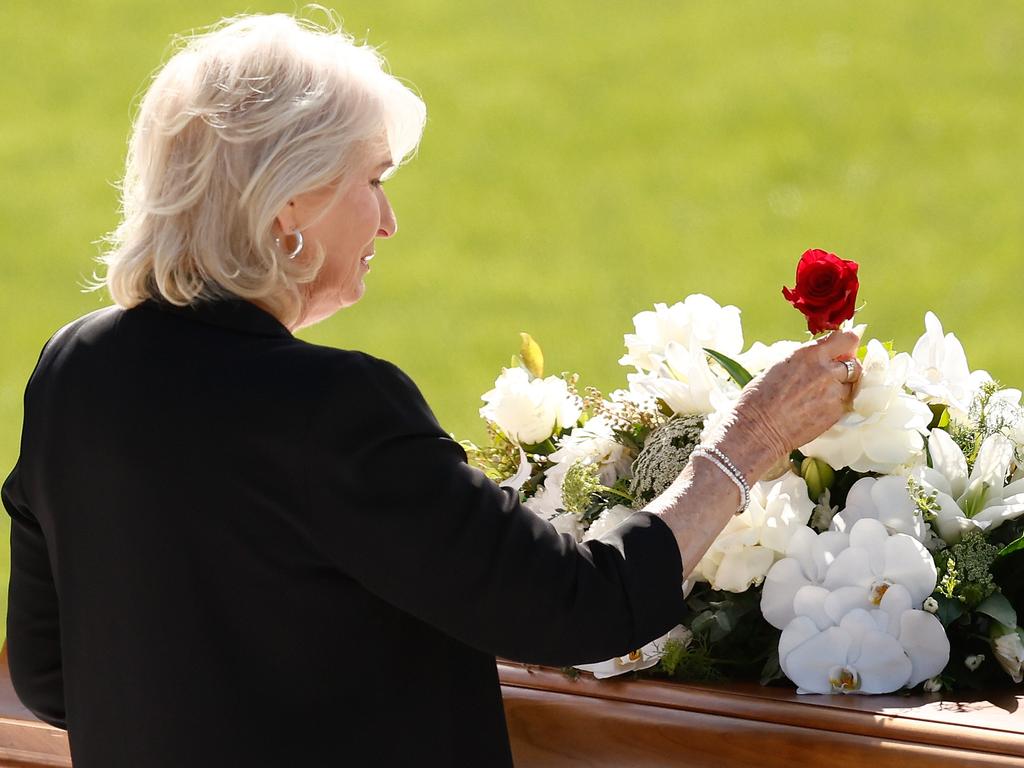 Maree Selwood places a rose during Troy Selwood's funeral service. Picture: Michael Willson