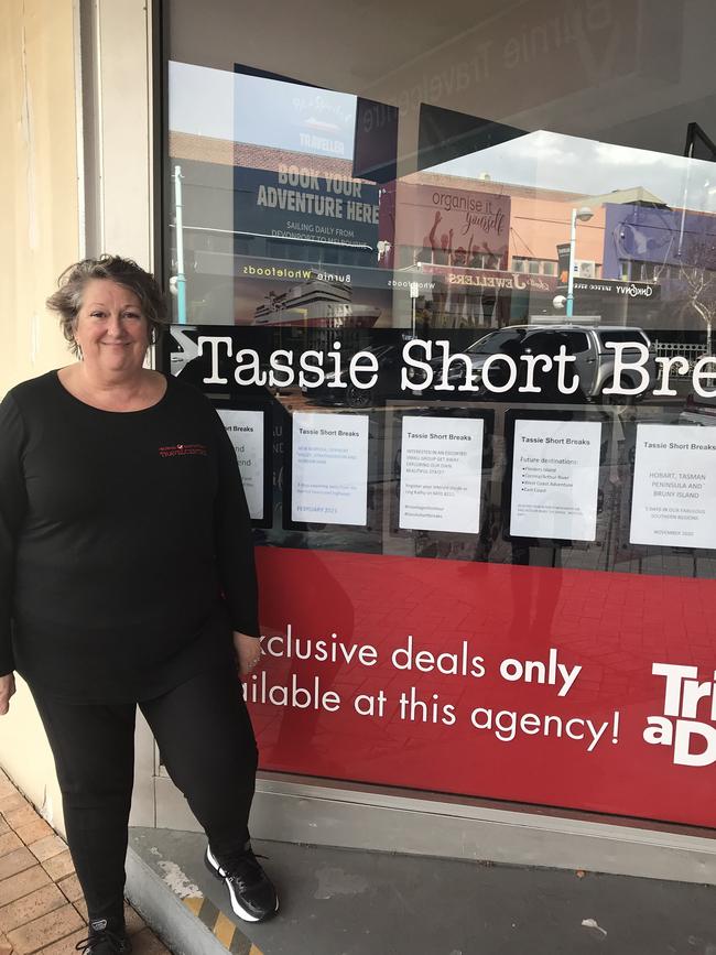 Burnie Travelcentre director Kathy Granger and the closed HelloWorld shop in Burnie.