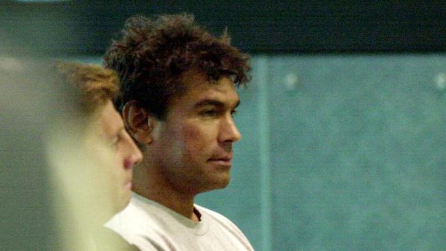 Suspect murderer Jean Eric Gassy at Sydney Airport under police escort being extradited to SA to face murder charges for shooting of SA mental health director Dr Margaret Tobin 11 Nov 2002.