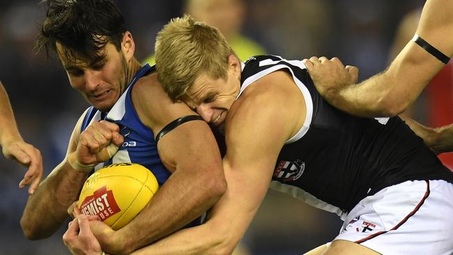 Nick Riewoldt lays a big tackle on Robbie Tarrant.