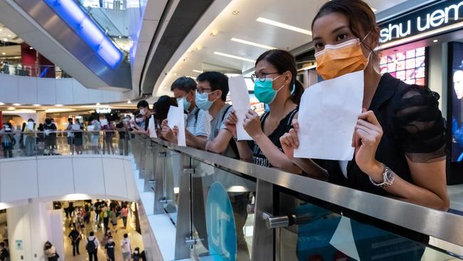 Protesters hold up blank papers during a demonstration in a mall in Hong Kong on July 6. Picture: Getty Images