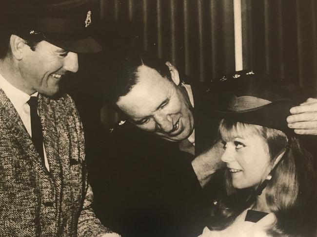 Little Pattie tries on a slouch hat ahead of her tour of Vietnam in 1966. Singer Col Joye is on the left.