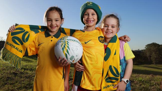 Six-year-olds Estelle Hockey, Madison Knipe and Annie MacGillivray from Little Kickers Brisbane are excited to support the Matildas at the World Cup. Picture: Lachie Millard