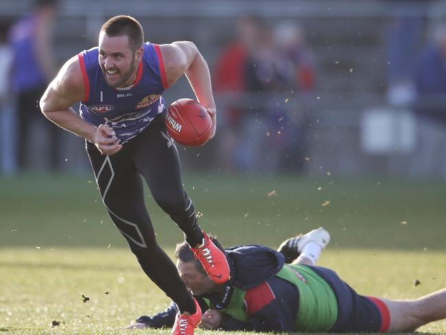 Matthew Sucking breaks the tackle of assistant coach Rohan Smith during a test on his injured achilles at training. Picture: Michael Klein