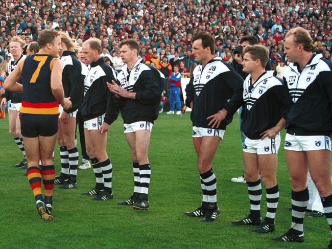 Geelong footballers standing in line as Adelaide Crows players make their way onto the ground. AFL football - Adelaide Crows vs Geelong match at Football Park 17 Apr 1994. /Football/AFL