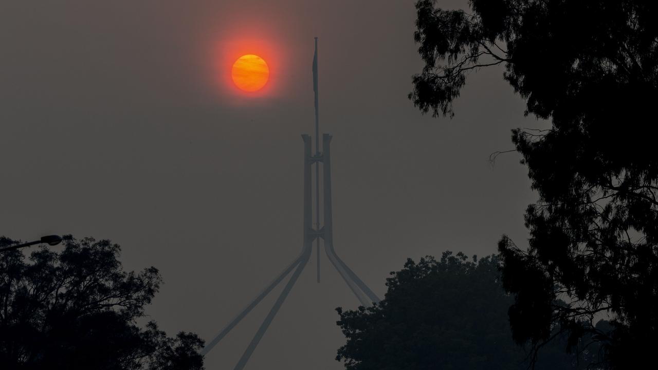 Parliament House through the smoke haze from the NSW fires which has once again blanketed the nation's capital, Canberra. Picture: Gary Ramage