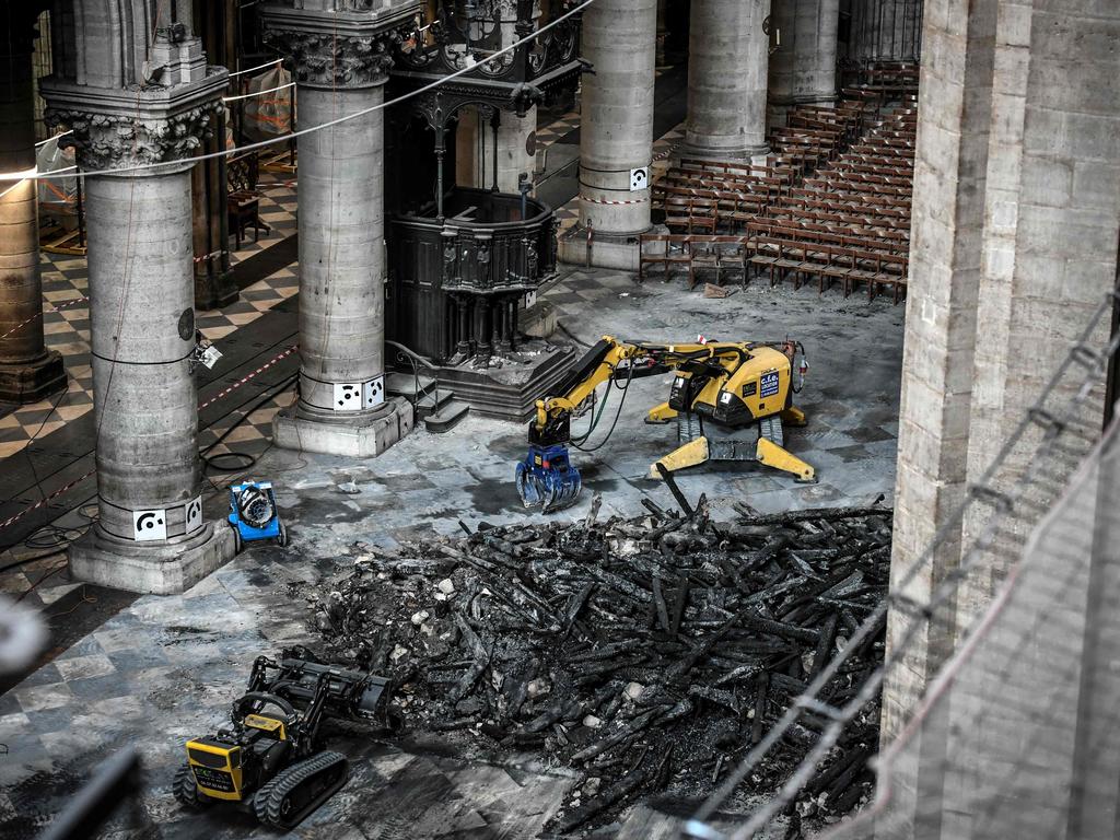 Excavators are seen during preliminary work in the Notre Dame cathedral in July, three months after the fire. Picture: Stephane de Sakutin/Pool/AFP