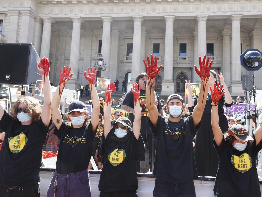 Protesters put red paint on their hands to show the country has “blood on their hands”. Picture : NCA NewsWire / Valeriu Campan