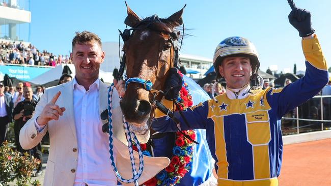 Swayzee's trainer Jason Grimson (left) and driver Cameron Hart celebrate the champ's NZ Cup win. Picture: HRNZ