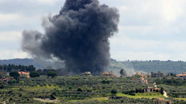 Smoke billows after an Israeli strike on the southern Lebanese border village of Tayr Harfa on Saturday. Picture: AFP