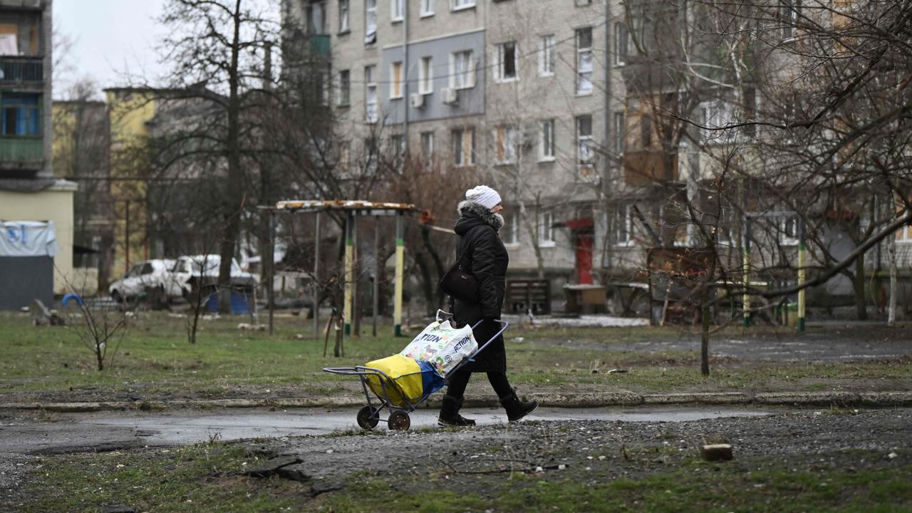 A local resident walks among damaged residential buildings in the town of Lyman, near the frontline in the Donetsk region. Picture: Genya SAVILOV / AFP