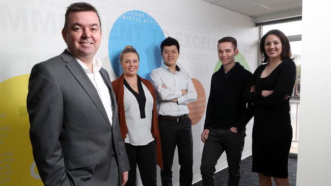 PrimeQ co-founder Andrew McAdams, left, with staff at the company’s head office in Kent Town. photo Calum Robertson