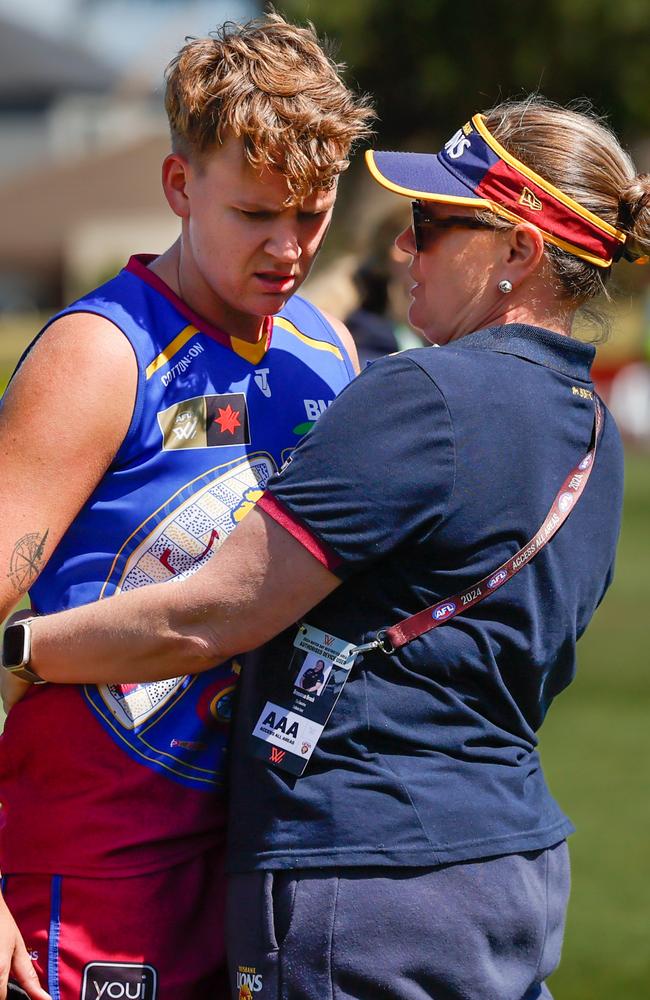 Dakota Davidson is consoled by a staff member. Picture: Dylan Burns/AFL Photos via Getty Images