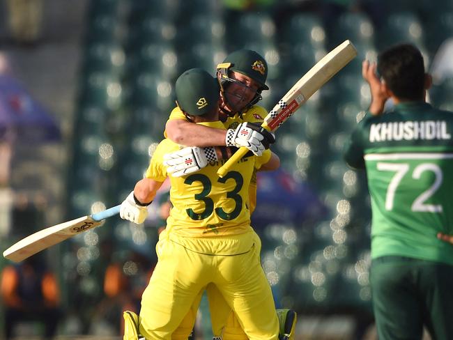 Ben McDermott celebrates with Marnus Labuschagne after scoring a century. Picture: Arif ALI / AFP