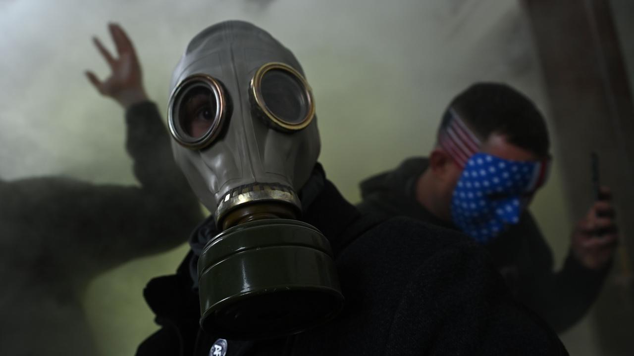 A supporter of US President Donald Trump wears a gas mask as he protests after storming the US Capitol on January 6, 2021, in Washington, DC. Picture: Brendan Smialowski / AFP