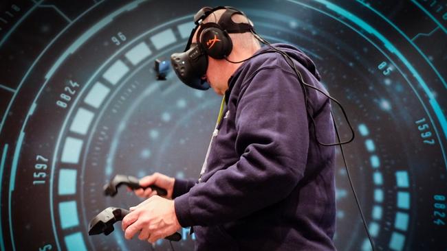 HTC’s virtual reality ... Chris Griffith tries out HTC Vive, a virtual reality headset at the CES tech show in Las Vegas. Picture: Supplied.