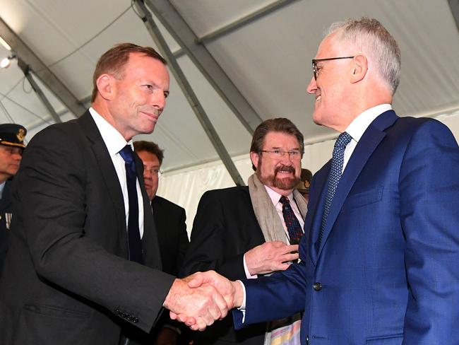 Australian Prime Minister Malcolm Turnbull right and former Australian Prime Minister Tony Abbott shake hands during the official opening of the Sir John Monash Centre at Villers-Bretonneux, Tuesday, April 24, 2018. Mr Turnbull is in France to commemorate ANZAC Day. (AAP Image/Lukas Coch) NO ARCHIVING