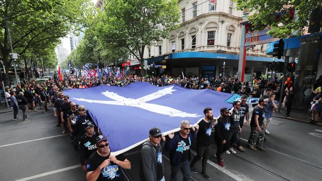 Union protesters carry a Eureka flag through the city. Picture: Alex Coppel