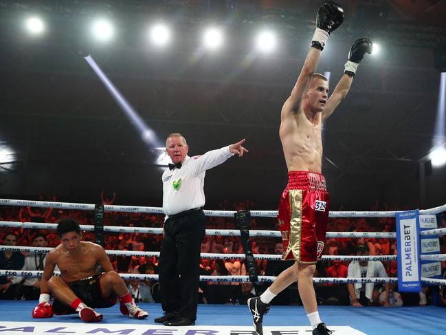 Wilson celebrates winning against Joe Noynay during their bout in Brisbane this year.