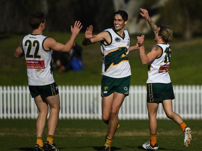 Ash Close (centre) celebrates a goal for Northcote Park this year. Picture: James Ross.