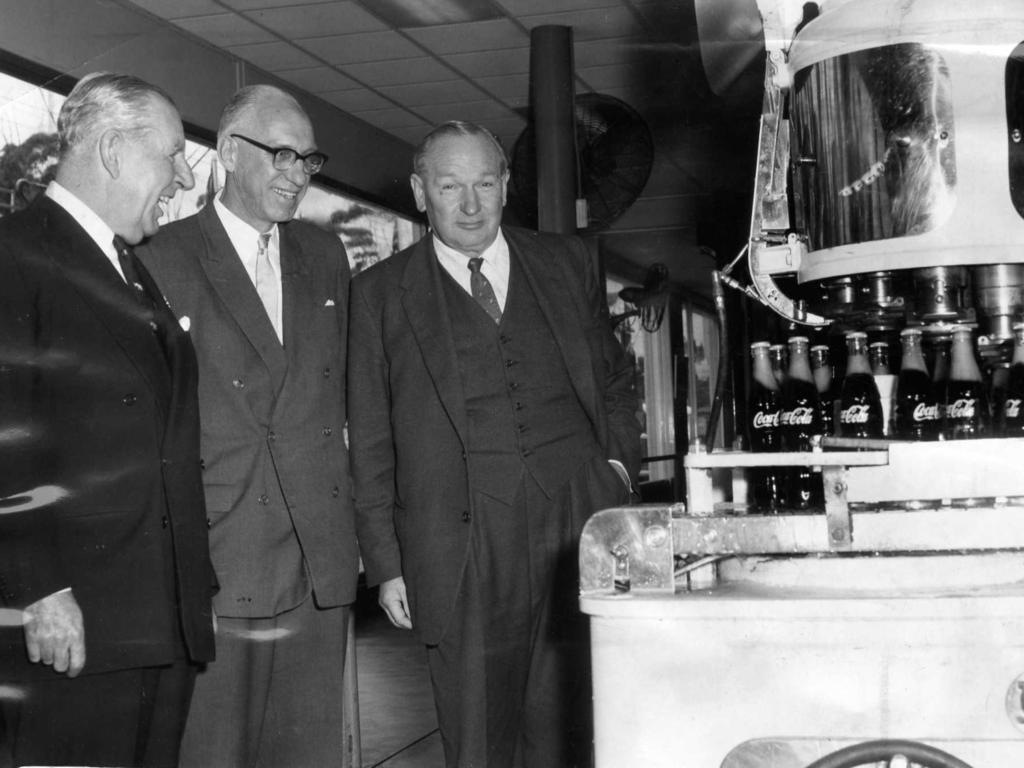 At the new bottling plant of Coca-Cola Bottlers, Thebarton, Sir Edward Hayward (Chairman of the Board of Directors of Coca-Cola) and SA Premier Sir Thomas Playford, watch plant operator Mr V Bagusauskas. September 1, 1961. Picture: R Hewett