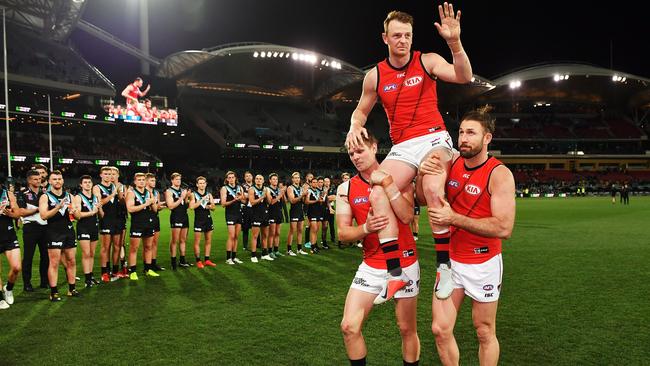 Brendon Goddard gets chaired off by Michael Hurley and Cale Hooker.