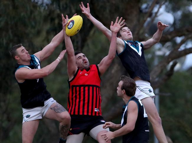 Laurimar and Panton Hill players fly for the mark.