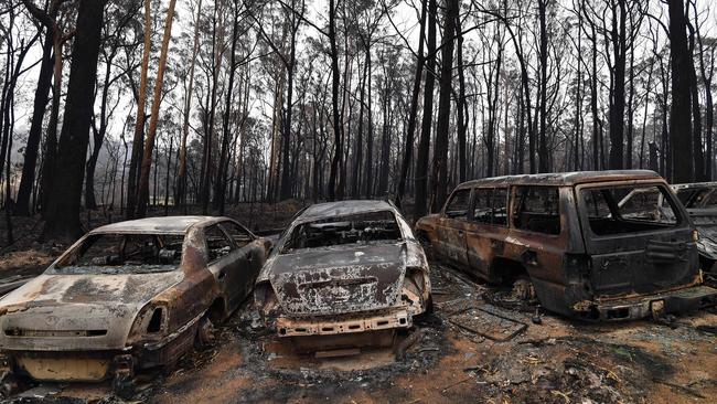 Vehicles gutted by bushfires in Mogo Village. Picture: Saeed Khan