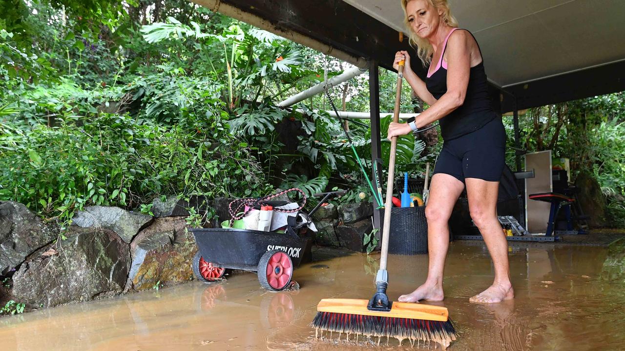 Danielle Pope sweeps out floodwater from her home at Federal. Picture: Patrick Woods.