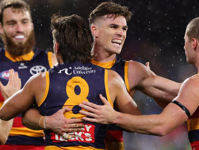 ADELAIDE, AUSTRALIA - JUNE 06: Ben Keays of the Crows hugs Josh Rachele of the Crows after he kicked a goal during the 2025 AFL Round 13 match between the Adelaide Crows and the Brisbane Lions at Adelaide Oval on June 6, 2025 in Adelaide, Australia. (Photo by Sarah Reed/AFL Photos via Getty Images)