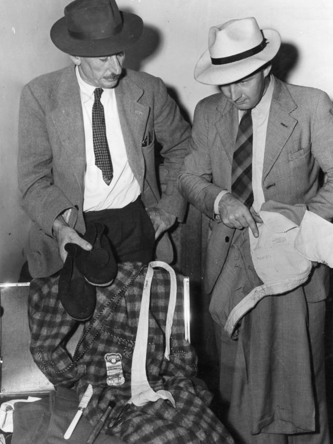 Police officers Detective Sergeant Lionel Leane with Constable D. Bartlett examining clothing found in the Somerton Man’s suitcase at Adelaide Railway Station on January 18, 1949. Picture: The Advertiser archives