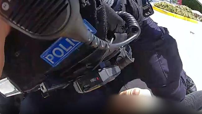 Police tackle a man to the ground after a foot chase from the shopping centre’s carpark. Pictures: QPS