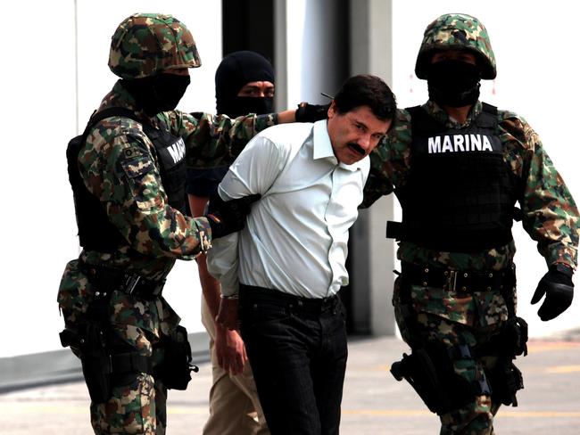 Mexican Navy soldiers with Joaquin “El Chapo” Guzman not long after his capture in 2014. Picture: Getty Images